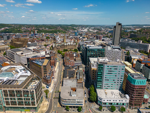 This aerial drone photo shows the city centre of Sheffield in South-Yorkshire, England. There are many large office buildings in the city centre.