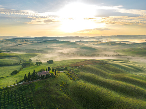 Tuscan landscape in fog hay field