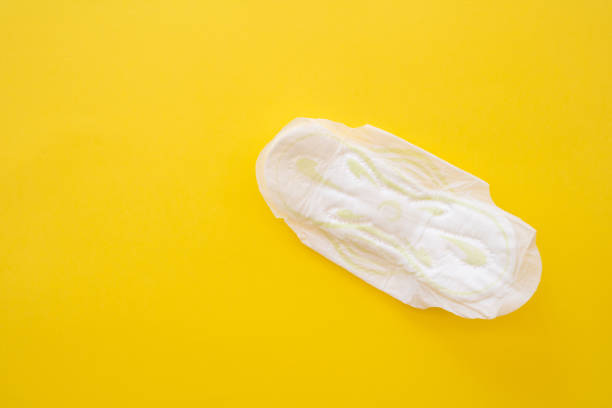 istock Women's sanitary napkin on a yellow background close-up. 1528041861