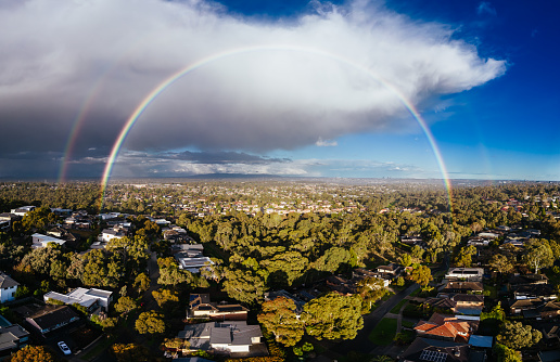 A winter's day storm and rainbow aerial view over the estate of Springthorpe near Bundoora in Macleod, Melbourne, Australia