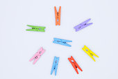 Clothes pegs - neat colored clothespins arranged in row - isolated vector on white background
