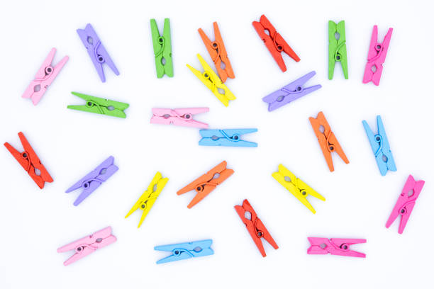 istock Multi colored clothes-pegs on white background, Clothes clip 1528070458