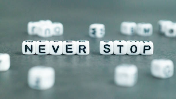 istock Never stop slogan in white block letter beads 1528101483