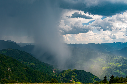 Storm rain in the mountains. Wall of falling rain in Soca valley, Slovenia. Bad weather forecast. Danger while hiking in the mountains