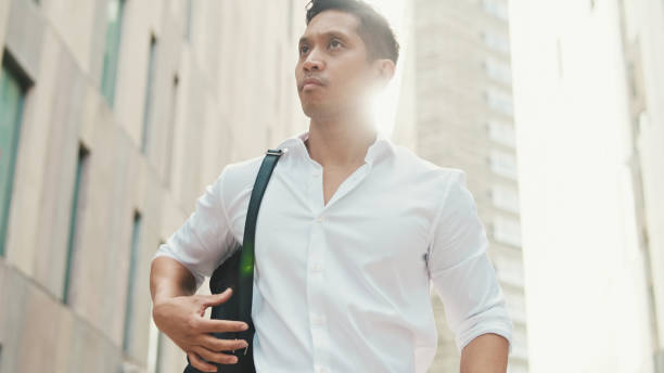 istock Young businessman walking through the business district 1528135735