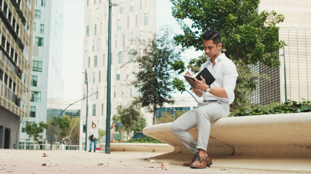 istock Young businessman making notes in personal paper planner 1528149897