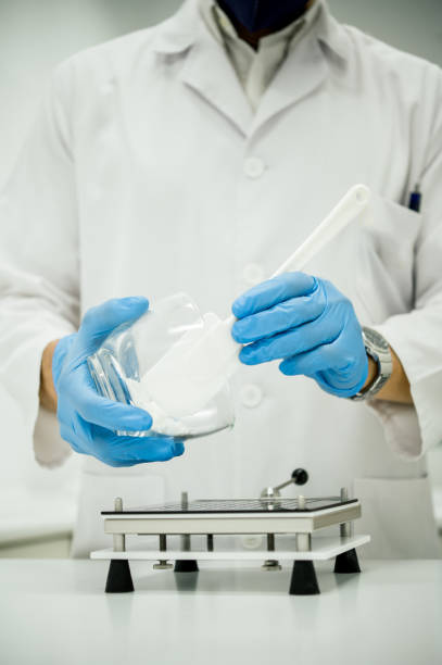 istock Crop pharmacist pouring powder into capsule filler while preparing medications 1528155790