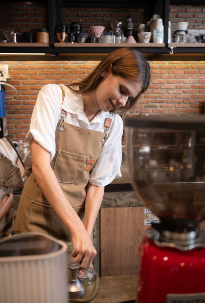 istock Close-up of barista hands using Portafilter for making espresso. 1528190609
