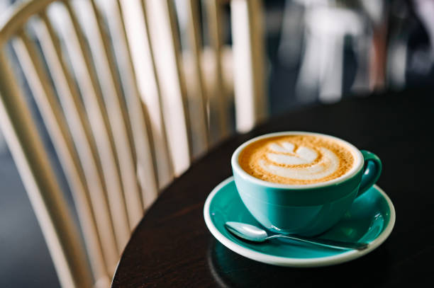 istock Coffee cappuccino in cup on wooden table in cafe 1528198159