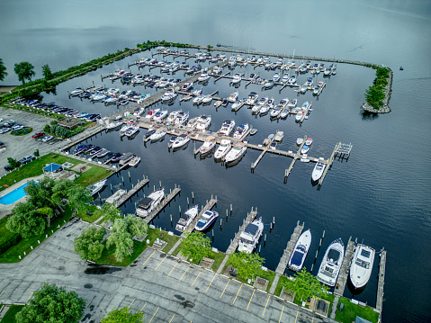 Various Boats Docked at a Marina on a Lake on a calm day