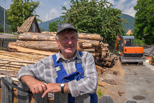 Bolzano, South Tyrol, Italy - June 20, 2023: Operator of a lumberyard in the town of Glorenza