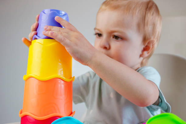 istock Little child playing colorful plastic toys pyramid 1528249339