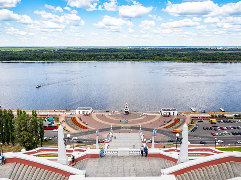 Nizhny Novgorod, Russia - June 26, 2023: above view of Volga river and Lower Volga embankment from Chkalov Stairs in Nizhny Novgorod city on summer day