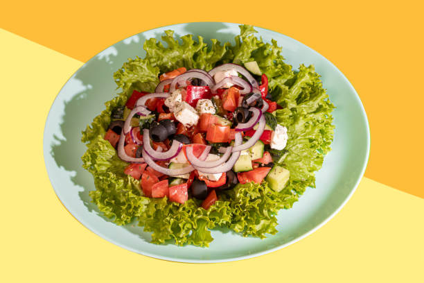 istock Salad with lettuce, chicken, cherry tomatoes and eggs. Seasoned with sauce. On a colored background. 1528251617