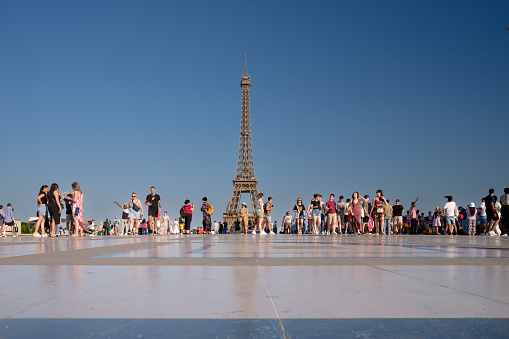 Paris, France - June 25, 2023 : Panoramic view of tourists enjoying the beautiful view of the Eiffel Tower of Paris France