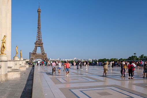 Paris, France - June 25, 2023 : Panoramic view of tourists enjoying the beautiful view of the Eiffel Tower of Paris France