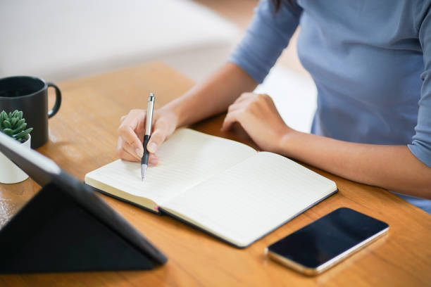 istock Online studying class for E learning. Smart student girl sitting at table watching lesson online and studying from home. 1528389582