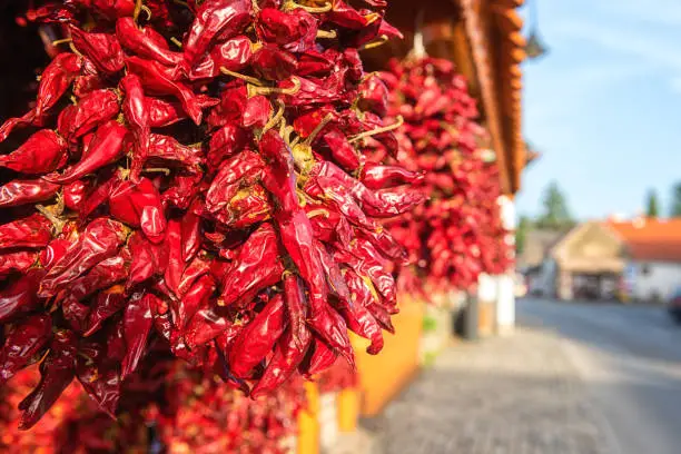 Famous Hungarian dried red pepper or paprika in souvenir shop on a cozy street of the Tihany village in summer time, outdoor travel background, Veszprem region, Hungary