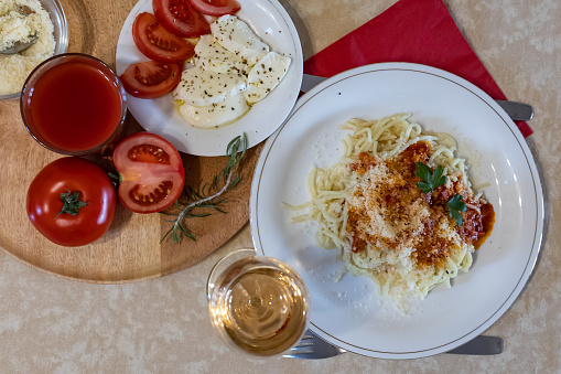 Making a fresh delicious Italian pasta, spaghetti with tomato sauce, garlic, basil and spices