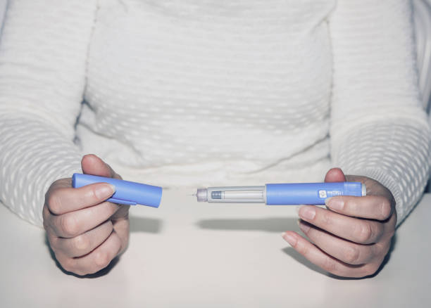 Woman holding an injection pen for diabetic. Insulin injection pen or insulin cartridge pen for diabetics. Medical equipment for diabetes parients. Woman holding an injection pen for diabetic. wegovy stock pictures, royalty-free photos & images
