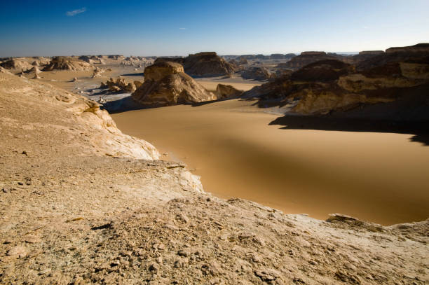 Wonderful white chalk rock formations in the White Desert view form above at sunset light - Egypt