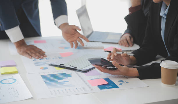 istock Close up of Business team analyzing income charts and graphs with modern laptop computer. Business analysis and strategy concept. 1528443537