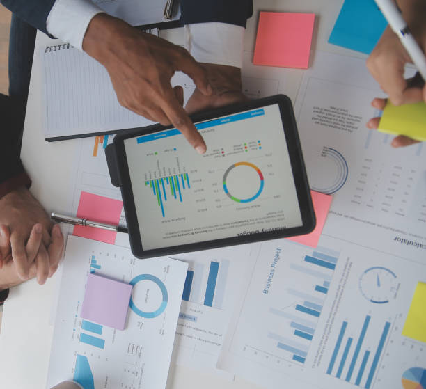 istock Close up of Business team analyzing income charts and graphs with modern laptop computer. Business analysis and strategy concept. 1528444567