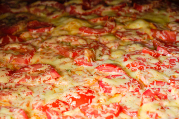 Pizza with tomatoes, sausage and cheese