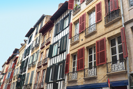 In Bayonne, in the Basque country, traditional buildings with balcony windows equipped with multicolored shutters and sometimes embellished with wooden half-timbering