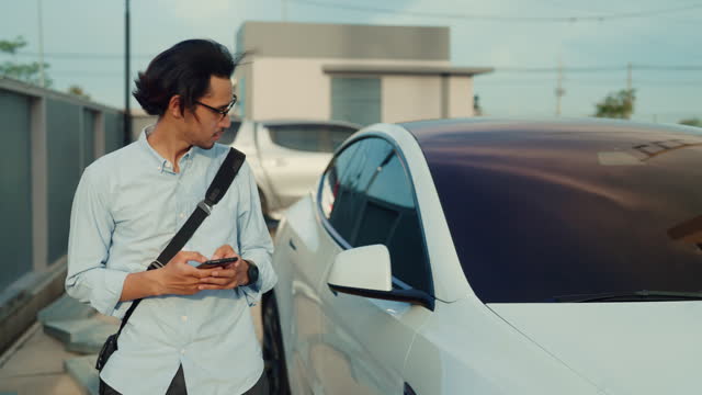 Young asian man unlock your car with your smartphone