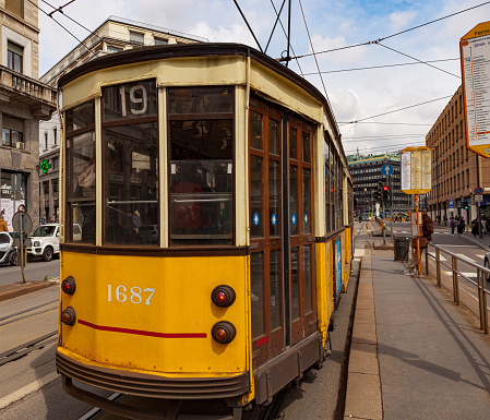 Milano, Italy - April 21, 2023: Milan's street traffic with yellow trolley car