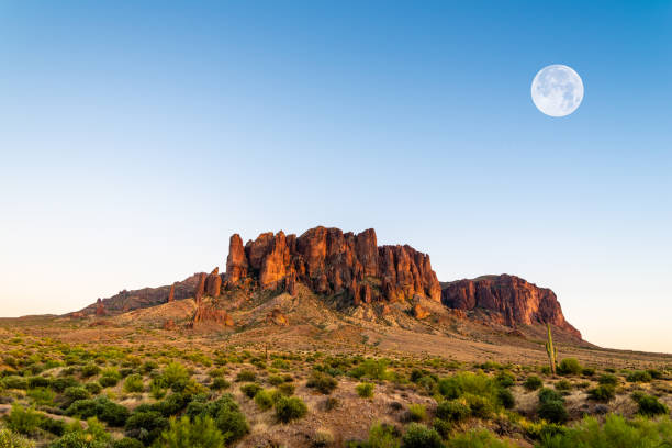 Full Moon Rises over Superstition Mountain The full moon rises over Superstition Mountain in Arizona. Photoshopped version. sonoran desert stock pictures, royalty-free photos & images