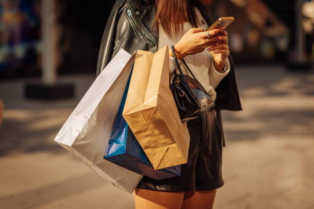 istock Shopping girl checking her phone 1528475581