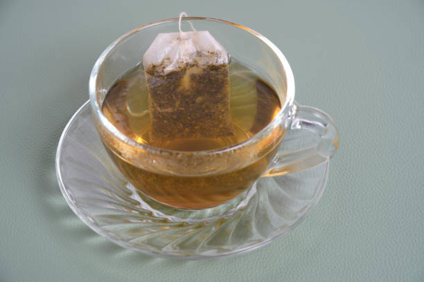 istock Transparent cup with tea and teabag. 1528482866