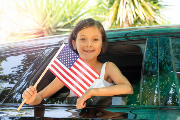 istock Girl Holding USA Flag 1528515310