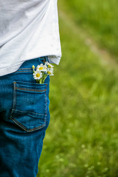 istock Chamomile flowers in a child's hand. 1528537563