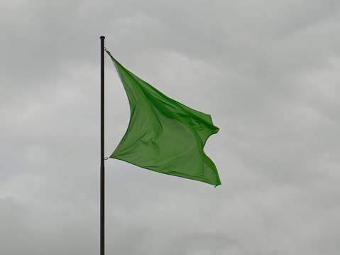 Rectangular green flag on a French beach\ngreen = calm sea so ‘bathing allowed and monitored’