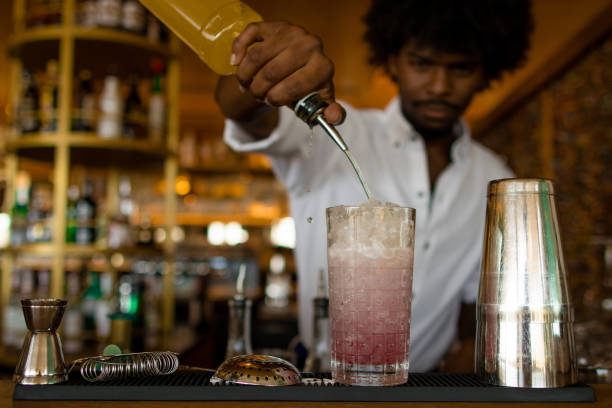 istock latin bartender with curly hair finishing a cocktail 1528554161