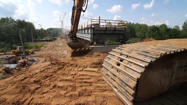 excavator works on a construction site, the process of building a new bridge