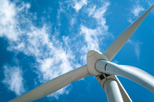 Wind turbine power generator and beautiful blue sky on the background. Sustainable resources background