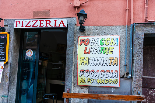 Vernazza Italy - April 26 2011; Signs on exterior wall of Pizzeria with menu offerings