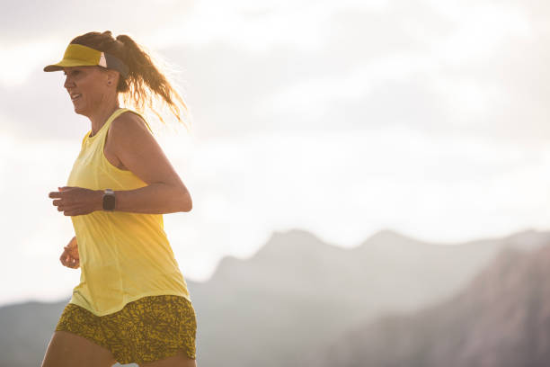 A healthy woman in her 50's cross country running through the desert landscape of Las Vegas, Nevada