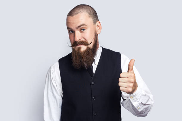istock Pleased friendly man showing thumb up, posing with like gesture, looking at camera. 1528724201