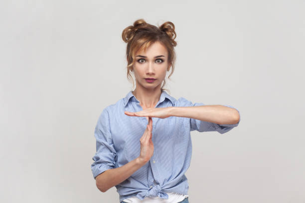 istock Woman making pause or break time gesture, timeout sign, asking to wait, deadline, time limit. 1528725784