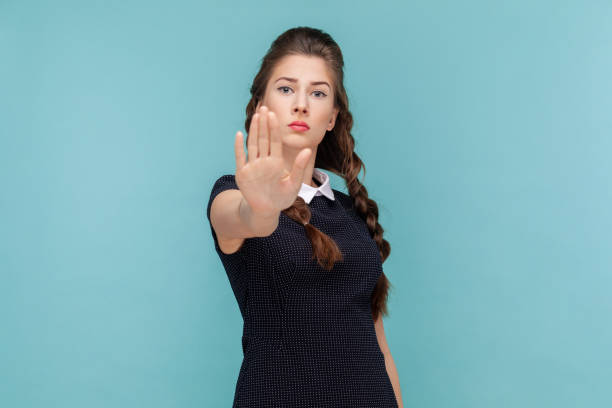 istock Serious strict woman standing and looking at camera, showing palm stop gestured, protect herself. 1528727841