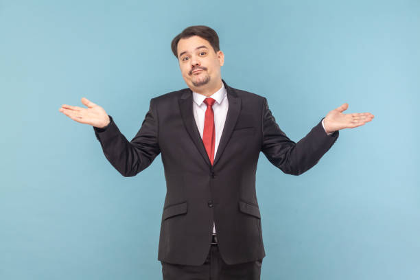 istock Confused man with mustache standing with spread hands, looking at camera, shrugging shoulders. 1528730473
