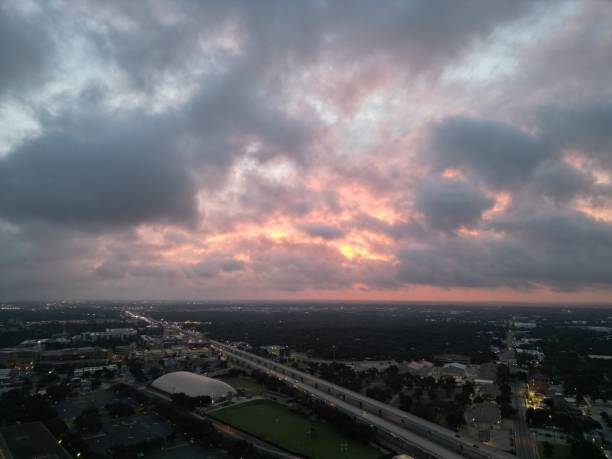 istock Fiery red and orange glowing storm clouds over an elevated highway. 1528802640