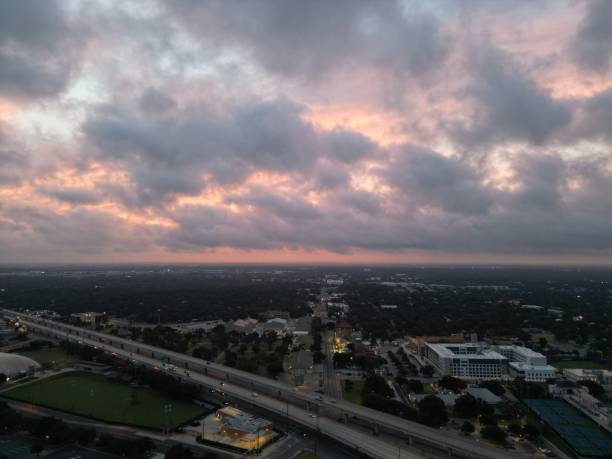 istock Fiery red and orange glowing storm clouds over an elevated highway. 1528803098