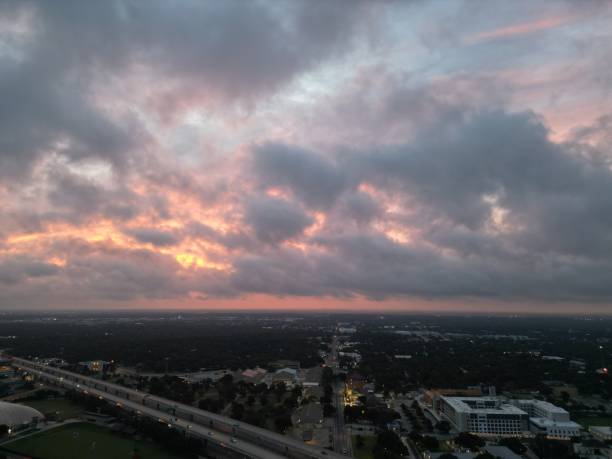 Fiery red and orange glowing storm clouds over an elevated highway.