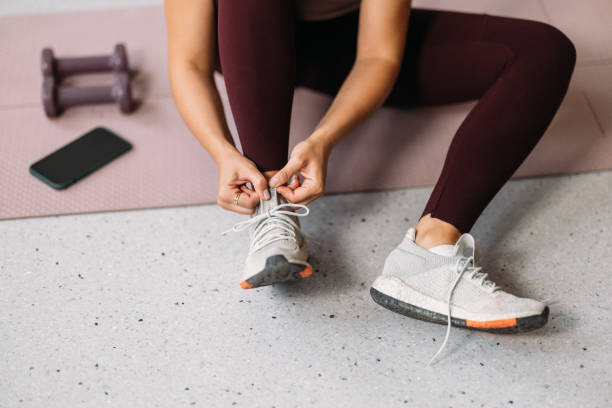 istock Unrecognizable Caucasian Woman Tying her Shoelace while Getting Ready to Work Out 1528848436